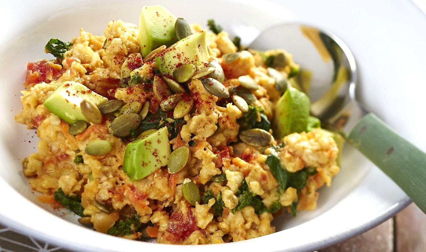 Cheesy Plant-Based Oatmeal Bowl With Kale and Pumpkin Seeds